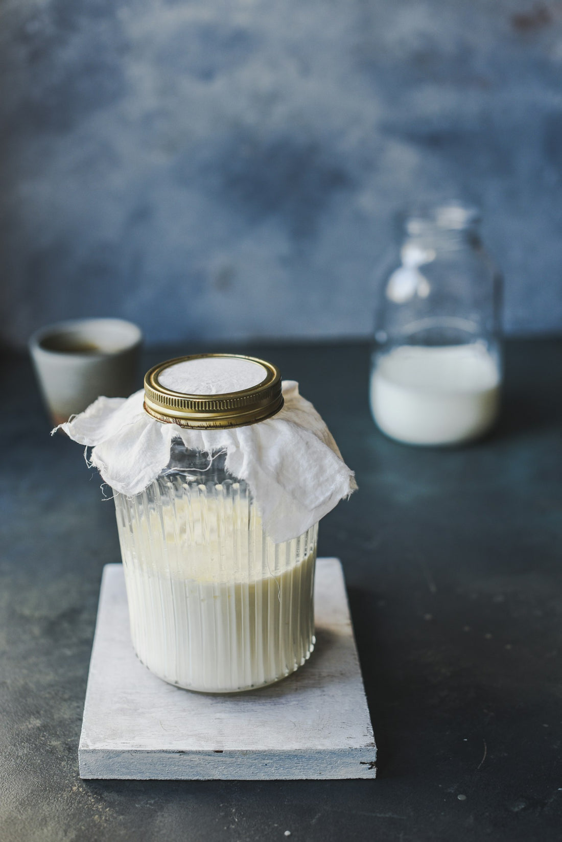 A glass jar of plain kefir, a fermented probiotic some owners consider as kefir for dogs